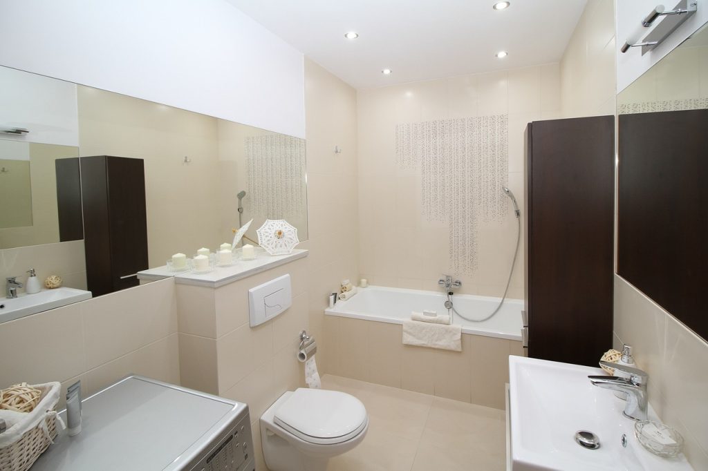 beige luxury bathroom with toilet and bathtub . plumbing and heating Toronto
