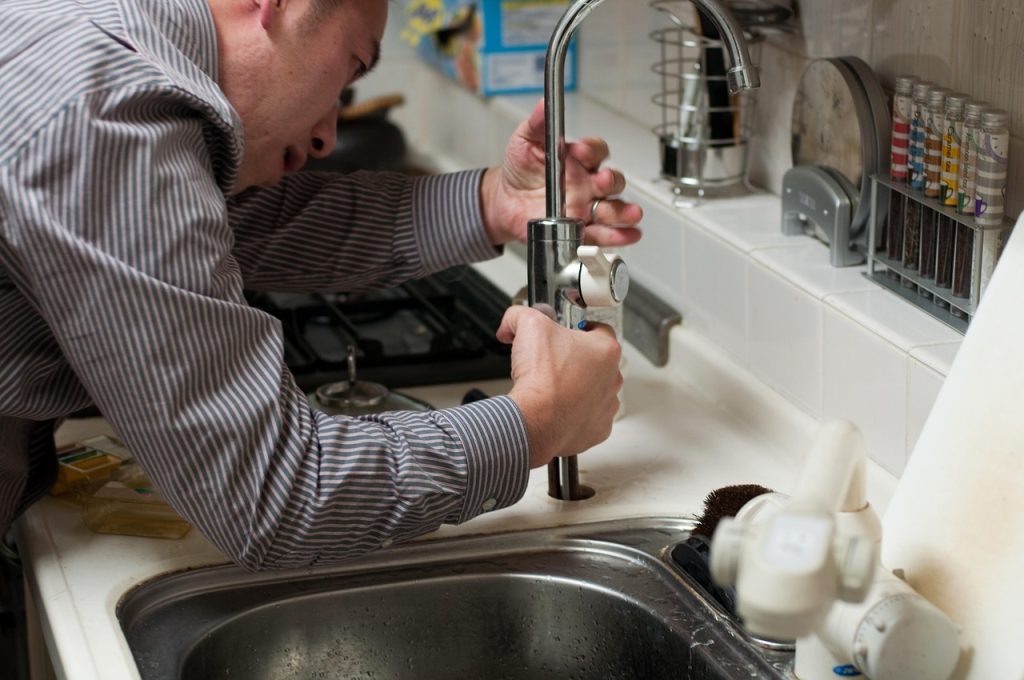 a plumber does emergency plumbing GTA on a kitchen sink